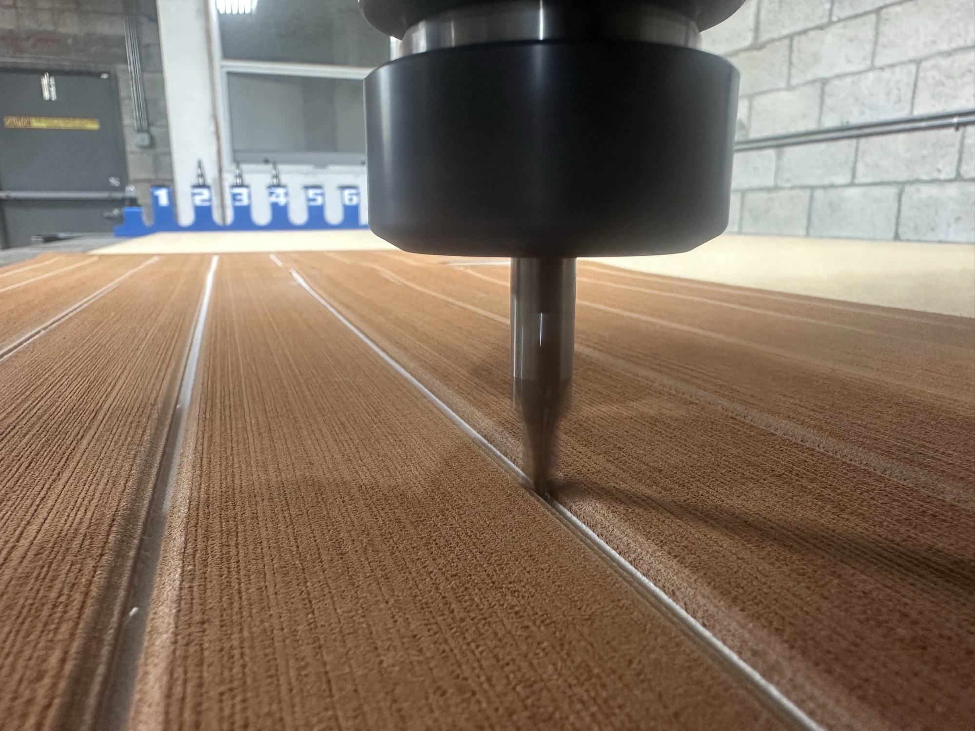 CNC router cutting a teak-pattern EVA foam sheet